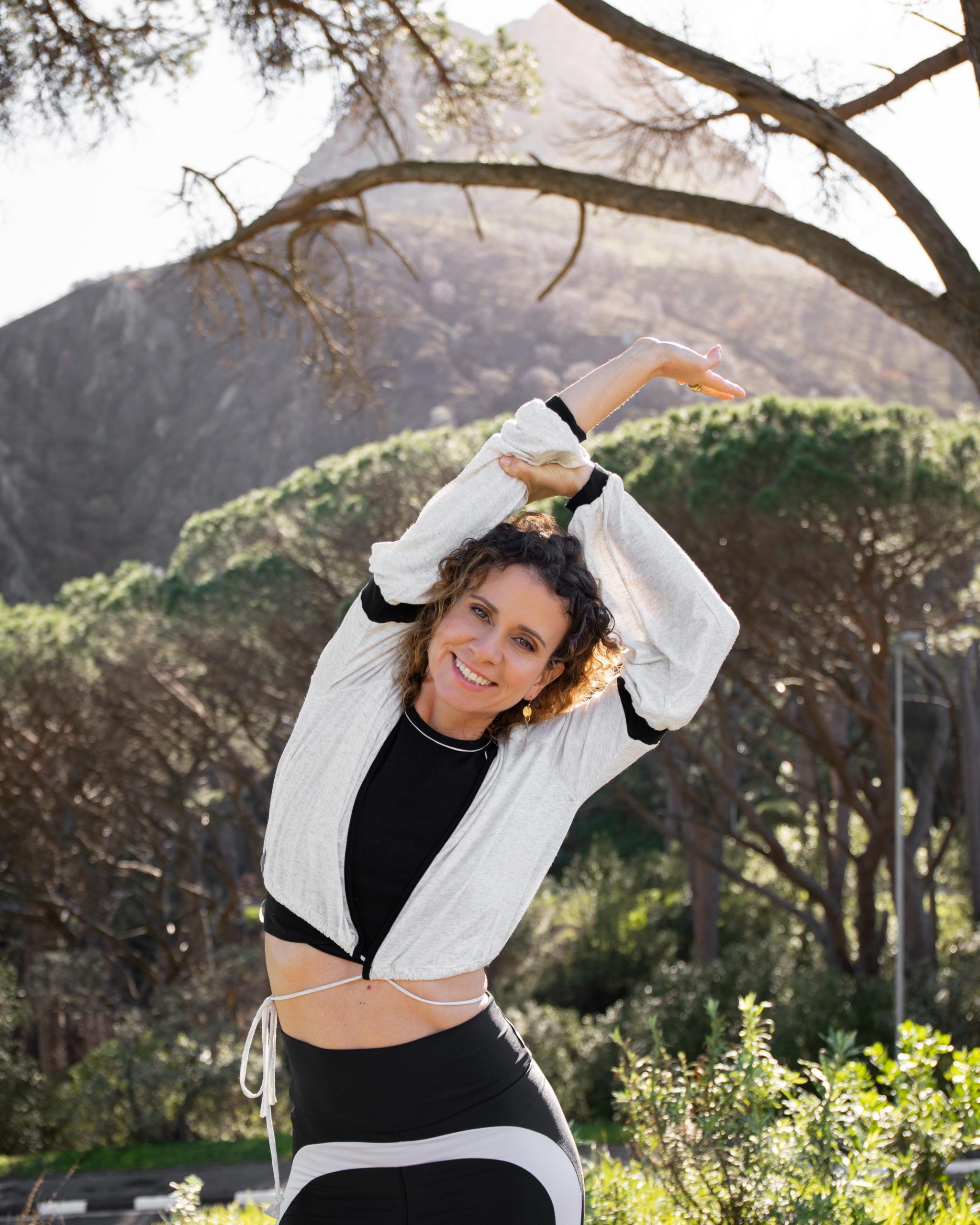 Rita Pires doing a yoga pose in front of the mountain